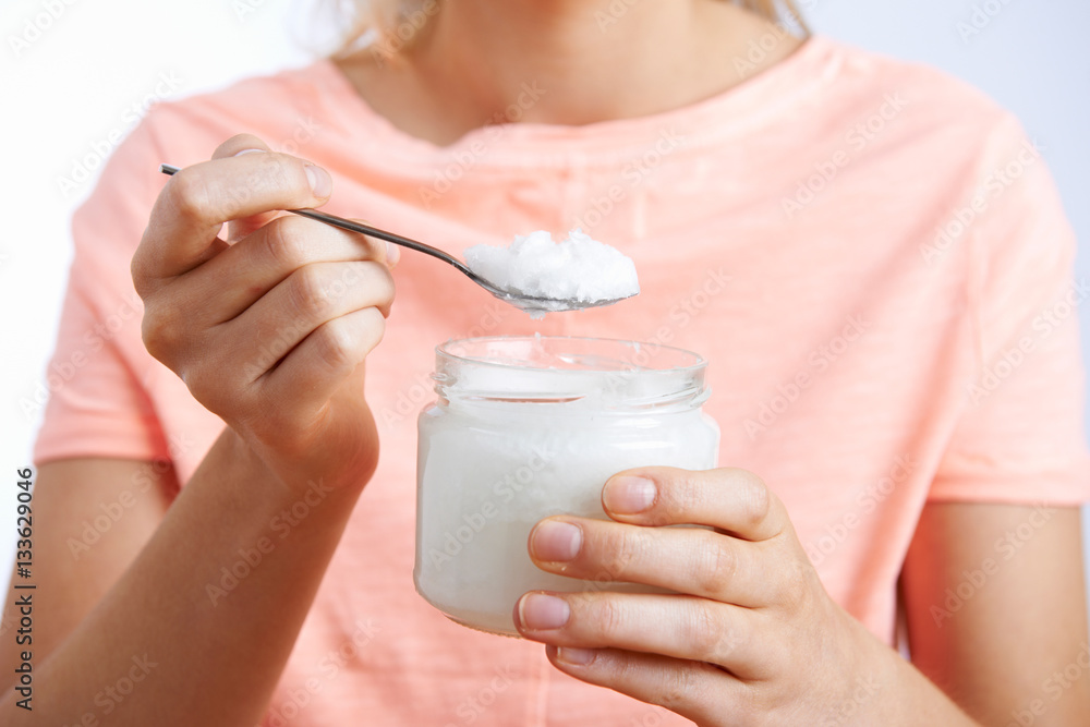 Close Up Of Woman With Spoonful Of Coconut Oil Close Up Of Woman With Spoonful Of Coconut Oil