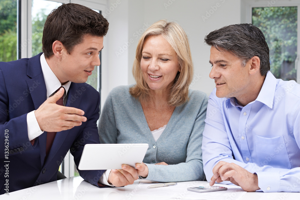 Mature Couple Meeting With Financial Advisor At Home Mature Couple Meeting With Financial Advisor At Home