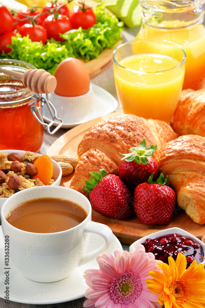 Breakfast consisting of croissants, coffee, fruits, orange juice Breakfast consisting of croissants, coffee, fruits, orange juice