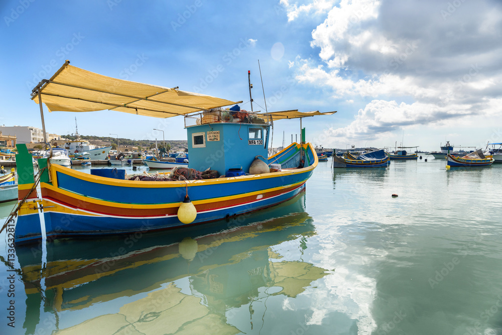 Traditional Maltese boats in the harbor of Marsaxlokk , Malta
