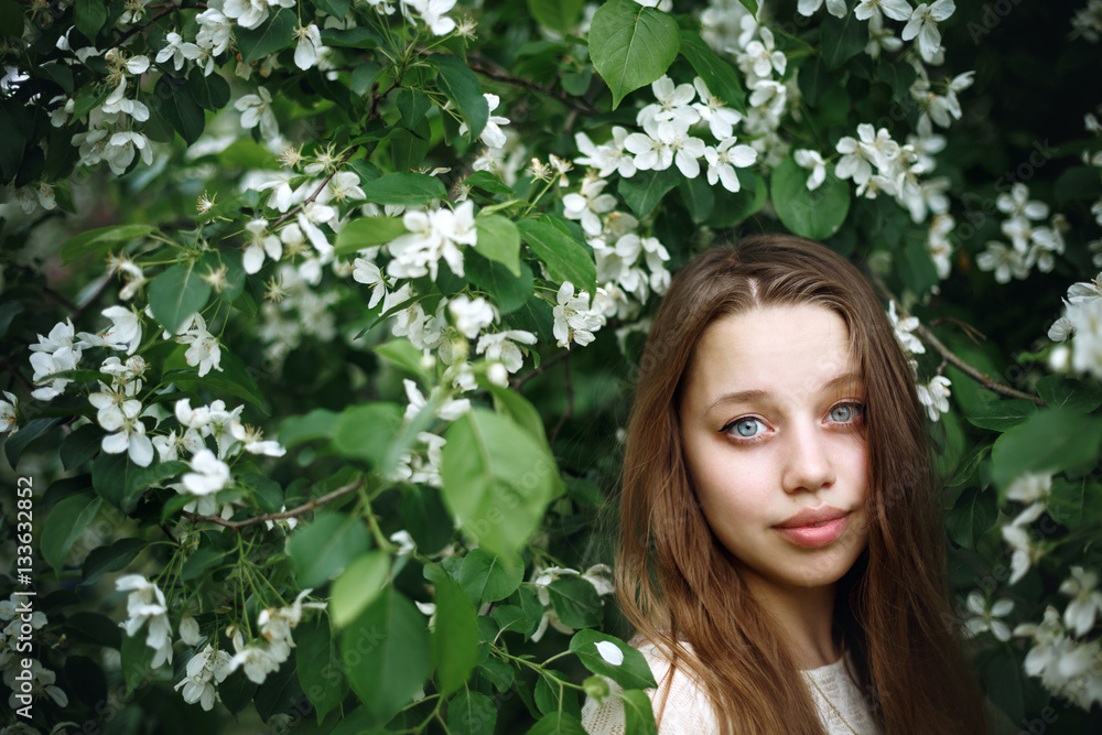 Portrait of young woman in blossoming spring tree Portrait of young woman in blossoming spring tree