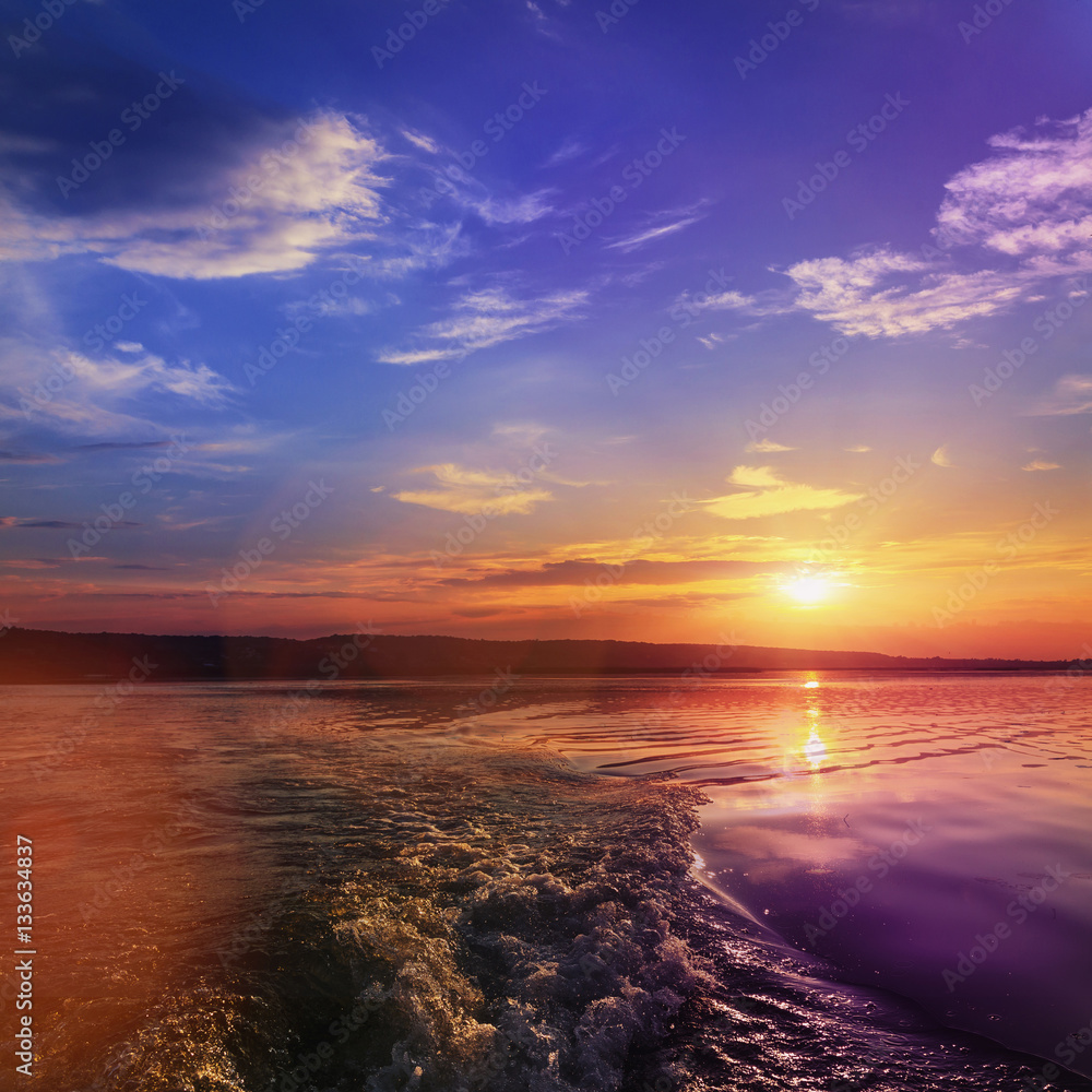 close-up texture of waves on the river at sunset, the trail from the boat. colorful clouds on the sky over the morning river. majestic misty sunrise. Beauty in the world. Ukraine. Dniester close-up texture of waves on the river at sunset, the trail from the boat. colorful clouds on the sky over the morning river. majestic misty sunrise. Beauty in the world. Ukraine. Dniester