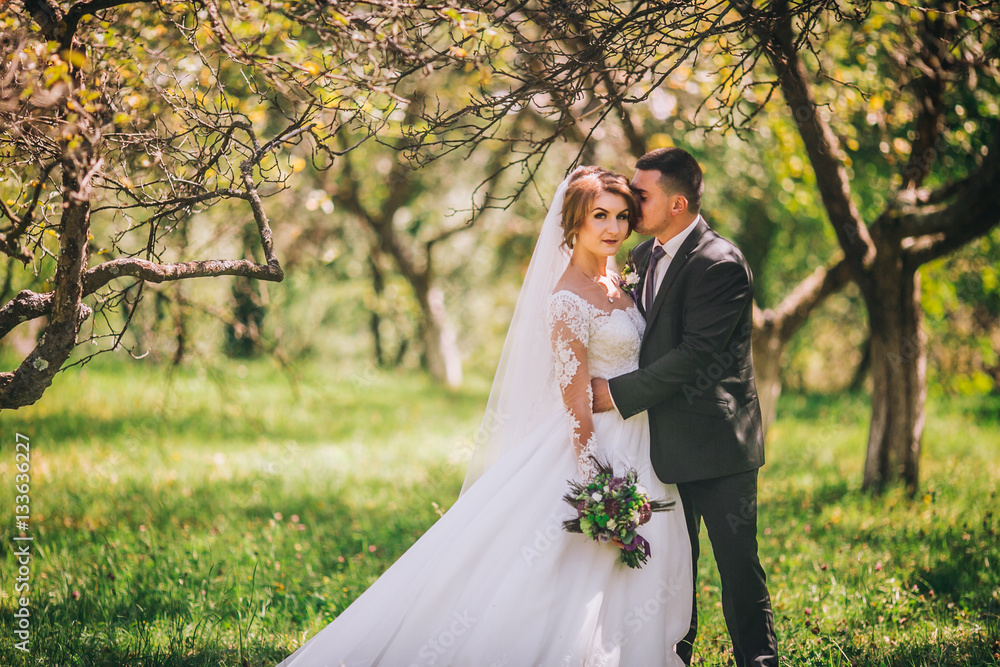 Happy wedding couple in the sunny garden Happy wedding couple in the sunny garden