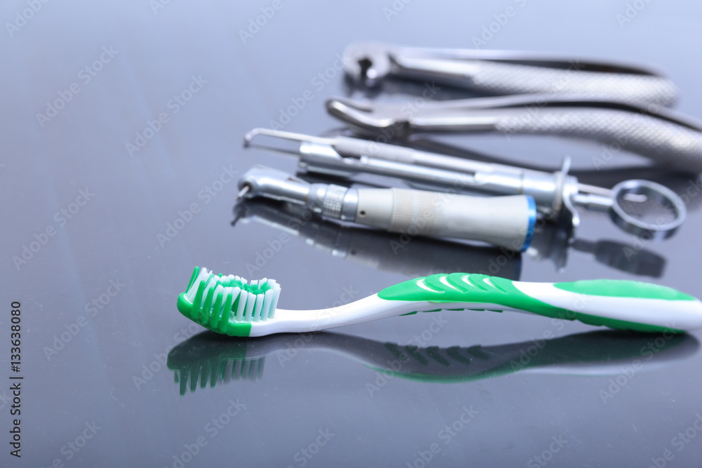 dental care toothbrush with dentist tools on mirror background. dental care toothbrush with dentist tools on mirror background.