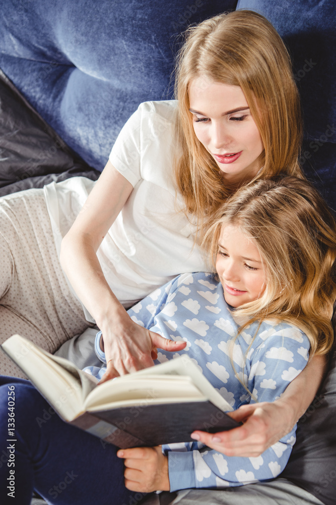 Mother and daughter reading book