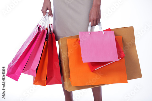 business women carrying colorful shopping bag isolated on white