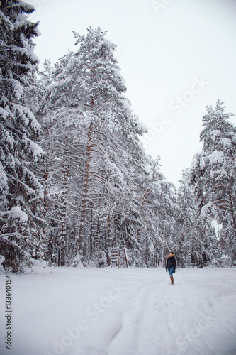 Happy young woman playing with snow