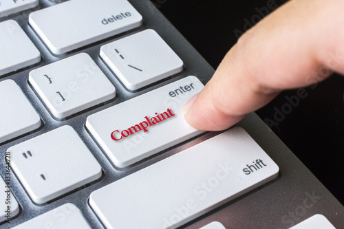 Finger on computer keyboard keys with Complaint word