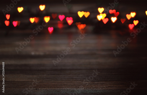 Heart bokeh, Valentine's day concept on wooden background photo