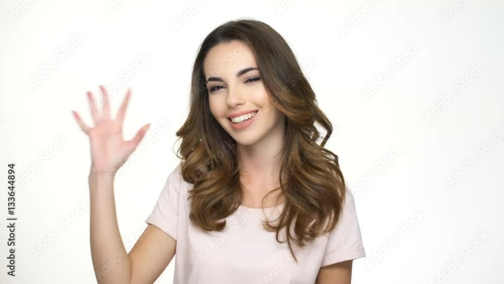 Cheerful young girl showing ok sign with fingers isolated on the white background Cheerful young girl showing ok sign with fingers isolated on the white background