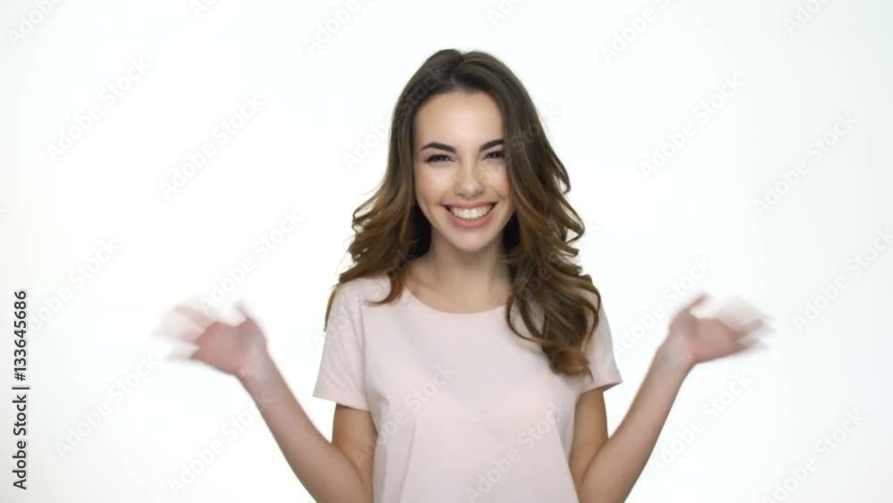 Excited young woman jumping out from aside and waving her hands isolated on the white backgroung Excited young woman jumping out from aside and waving her hands isolated on the white backgroung