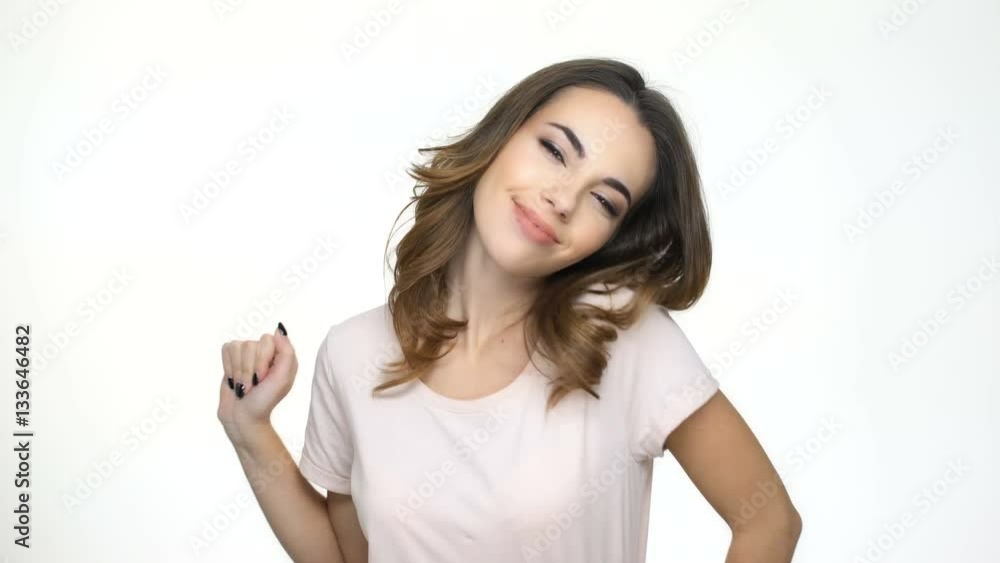Young bored woman yawning and smiling while standing isolated on a white background Young bored woman yawning and smiling while standing isolated on a white background