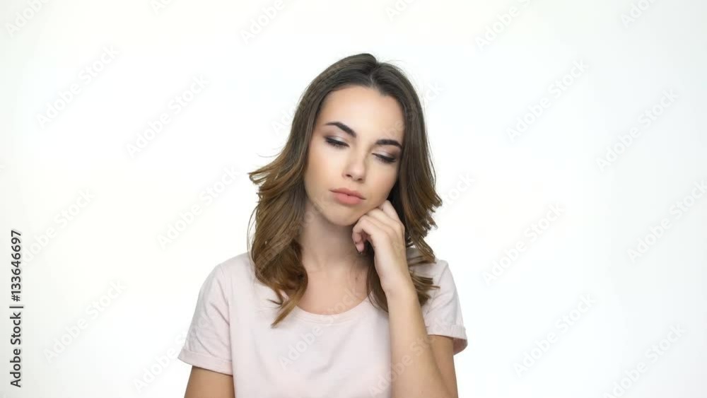 Young tired woman leaning on hand and falling asleep isolated on a white background Young tired woman leaning on hand and falling asleep isolated on a white background