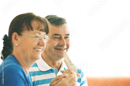 Senior couple eating cookies