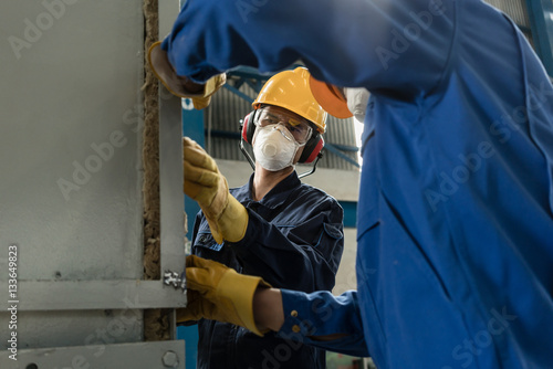 Two blue-collar workers wearing protective equipment photo