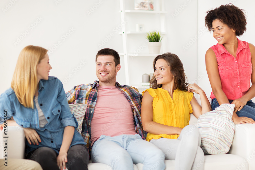 group of happy friends talking at home group of happy friends talking at home