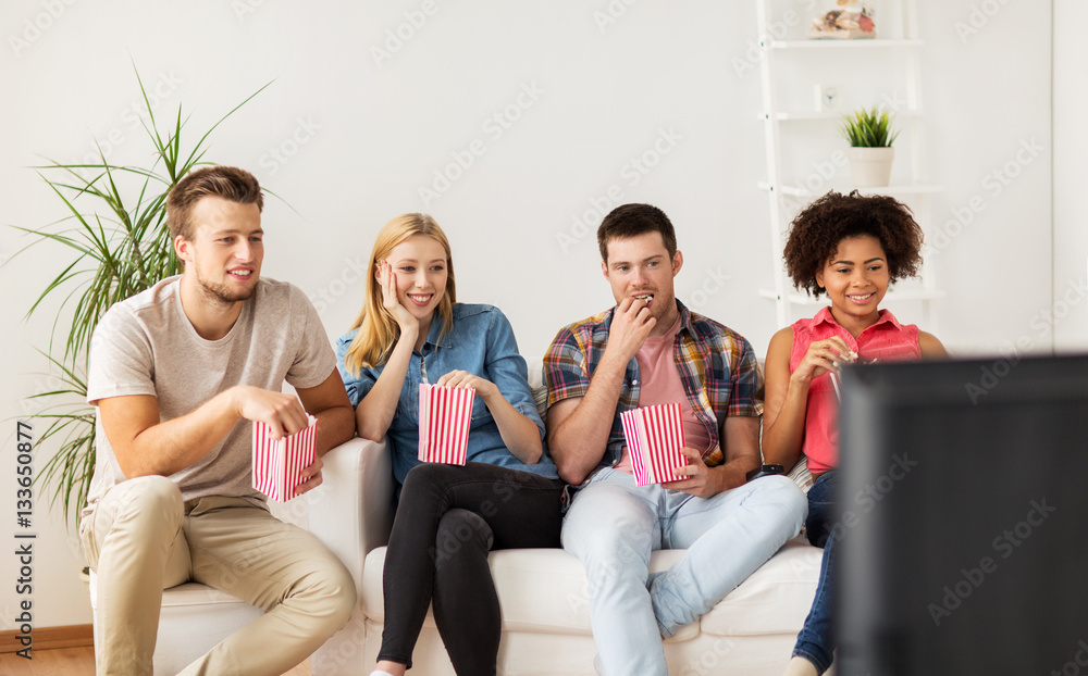 happy friends with popcorn watching tv at home happy friends with popcorn watching tv at home