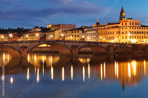 By night beautiful view of bridge Carraia crossing Arno river, Firenze, Tuscany, Italy