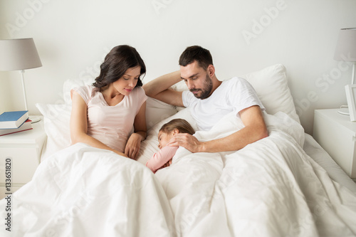 happy family sleeping in bed at home © Syda Productions