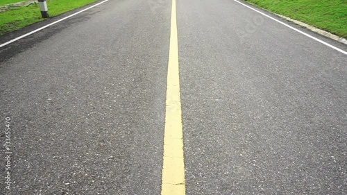 Wallpaper Mural Asphalt road perspective with yellow line panning up. Guiding way to surround by with green nature Torontodigital.ca
