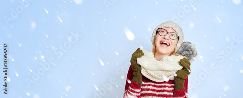 Woman in the snow in winter in the middle of snowflakes