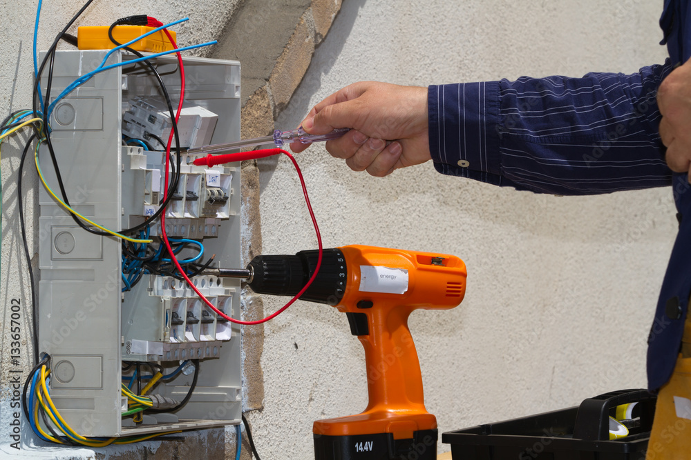 electrician at work with an electric panel electrician at work with an electric panel