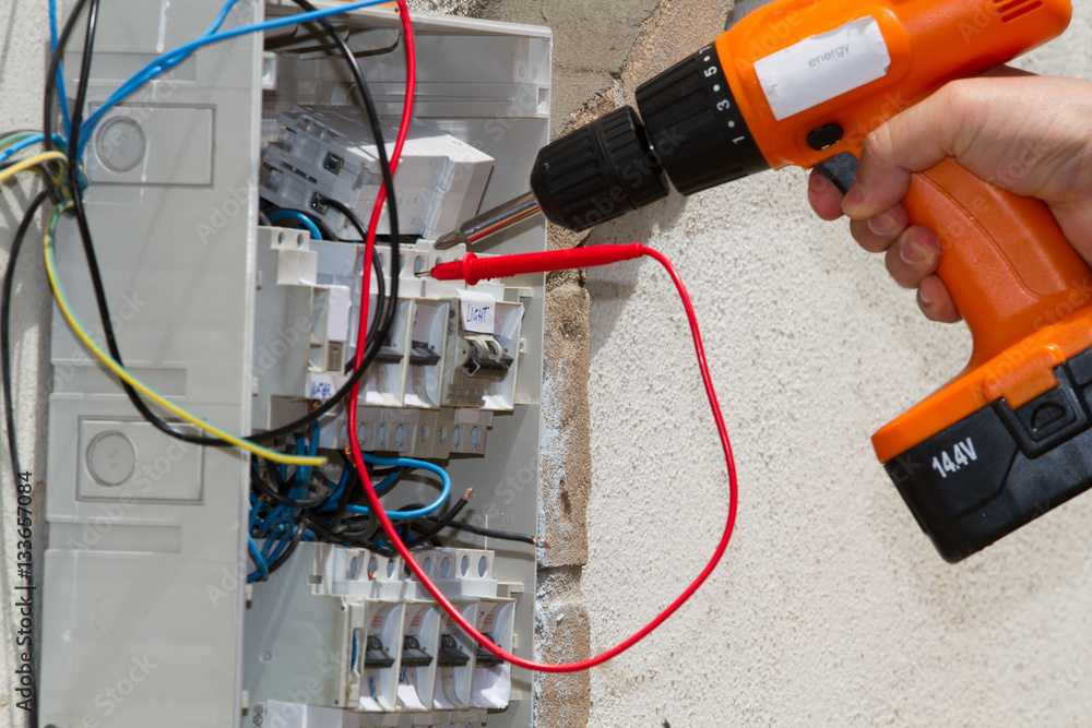 electrician at work with an electric panel electrician at work with an electric panel