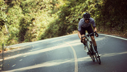 фотографія Asian men are cycling road bike in the morning