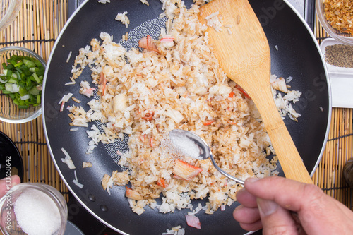 Chef putting sugar for cooking rice photo