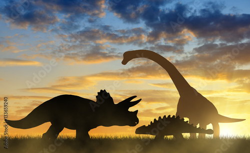 Silhouette of dinosaurs in the sunset.