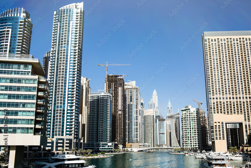 Tall skyscrapers built on both sides of the river in Dubai Tall skyscrapers built on both sides of the river in Dubai