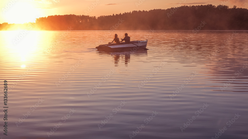 Romantic golden sunset river lake fog loving couple small rowing boat Romantic date beautiful Lovers ride boat during beautiful sunset Happy couple woman man together relaxing water nature around