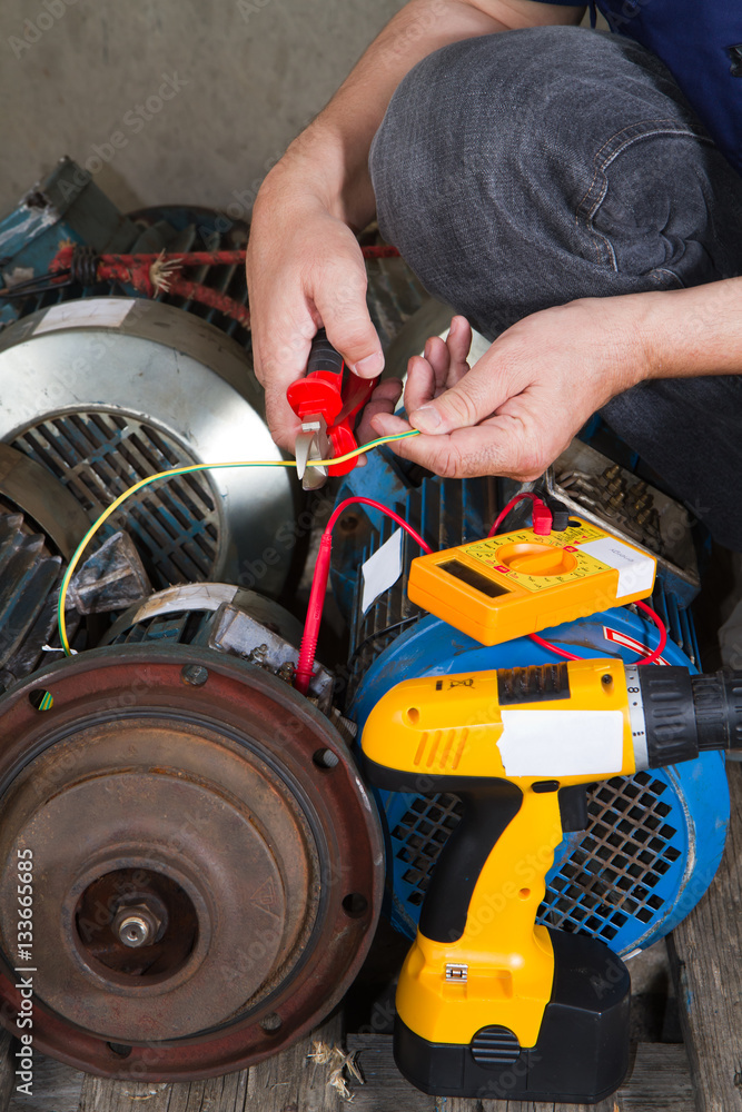 repairman during maintenance work of electric motors