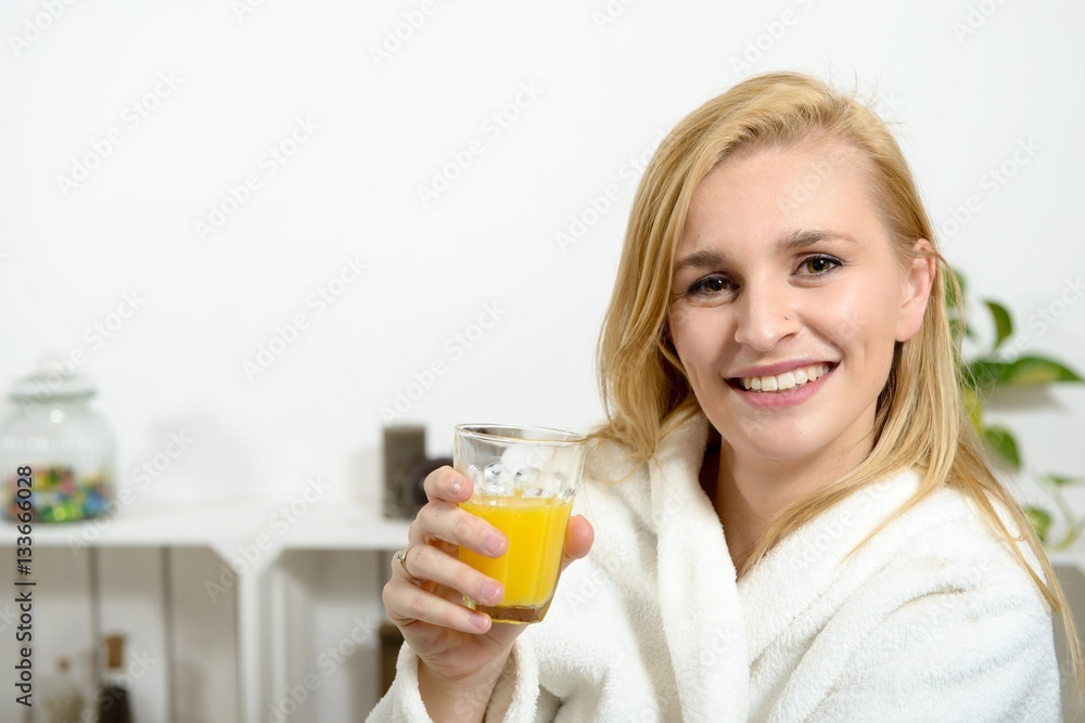 beautiful young blonde woman drinking orange juice beautiful young blonde woman drinking orange juice