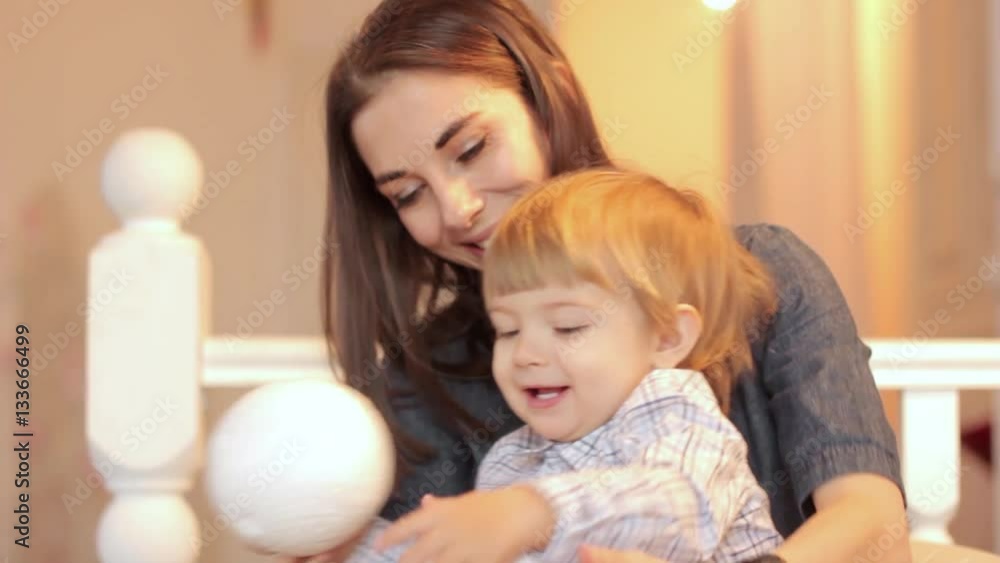 a child plays with a ball with mom a child plays with a ball with mom