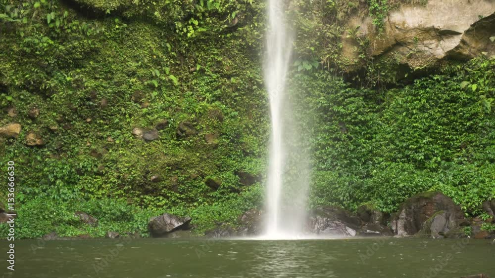 Beautiful waterfall in green forest in jungle. Waterfall in the mountains. Tropical rain forest with waterfall. Philippines, Camiguin. 4K video. Travel concept. Beautiful waterfall in green forest in jungle. Waterfall in the mountains. Tropical rain forest with waterfall. Philippines, Camiguin. 4K video. Travel concept.