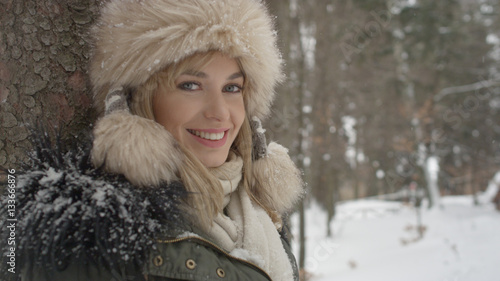 Portrait of smiling woman enjoying wintertime. © therabbithole