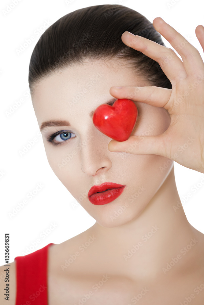 beautiful brunette woman holding red heart in front of the face. beautiful brunette woman holding red heart in front of the face.