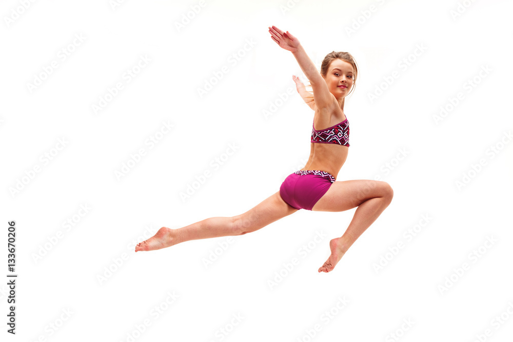 The teenager girl doing gymnastics exercises isolated on white background