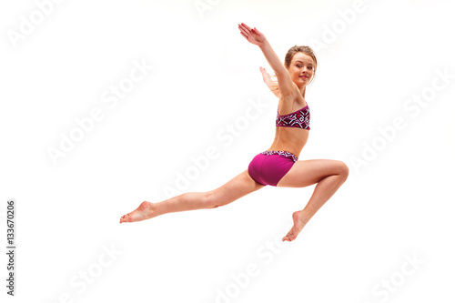 The teenager girl doing gymnastics exercises isolated on white background