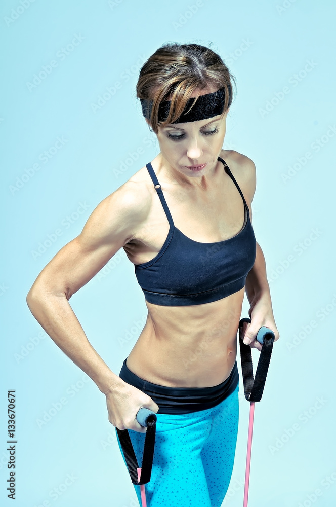 Sport fitness woman doing exercise with stretching expander Sport fitness woman doing exercise with stretching expander