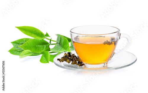 green tea leaf with a glass of tea on white background