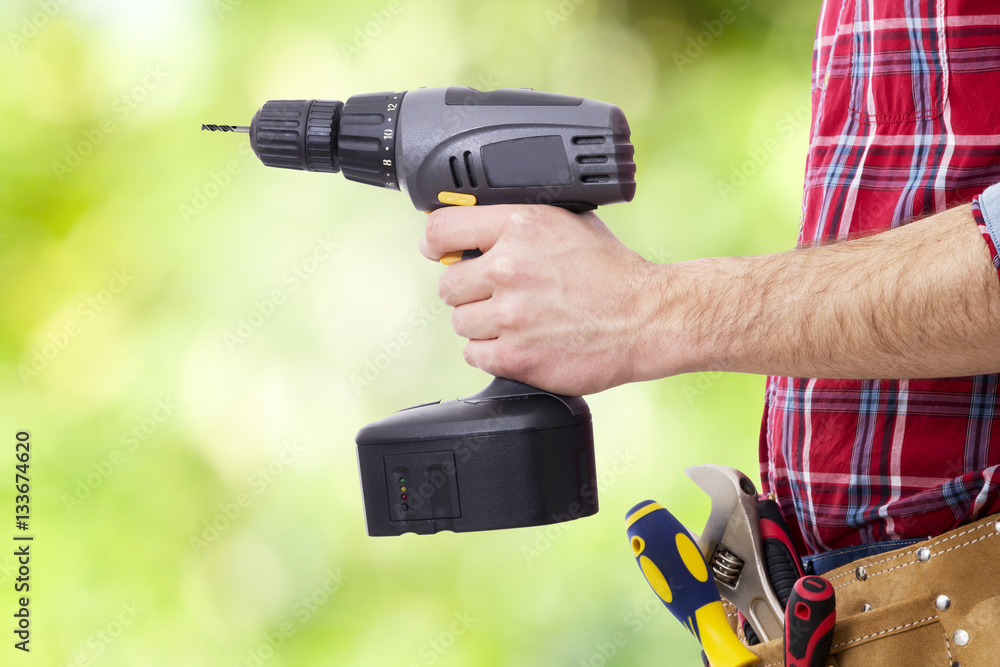 hand with the drill or screwdriver isolated, DIY and tools hand with the drill or screwdriver isolated, DIY and tools