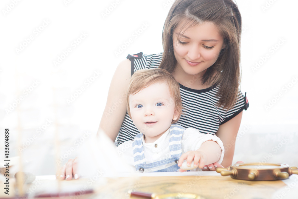 Happy sailor kid and mom playing indoors. Happy sailor kid and mom playing indoors.
