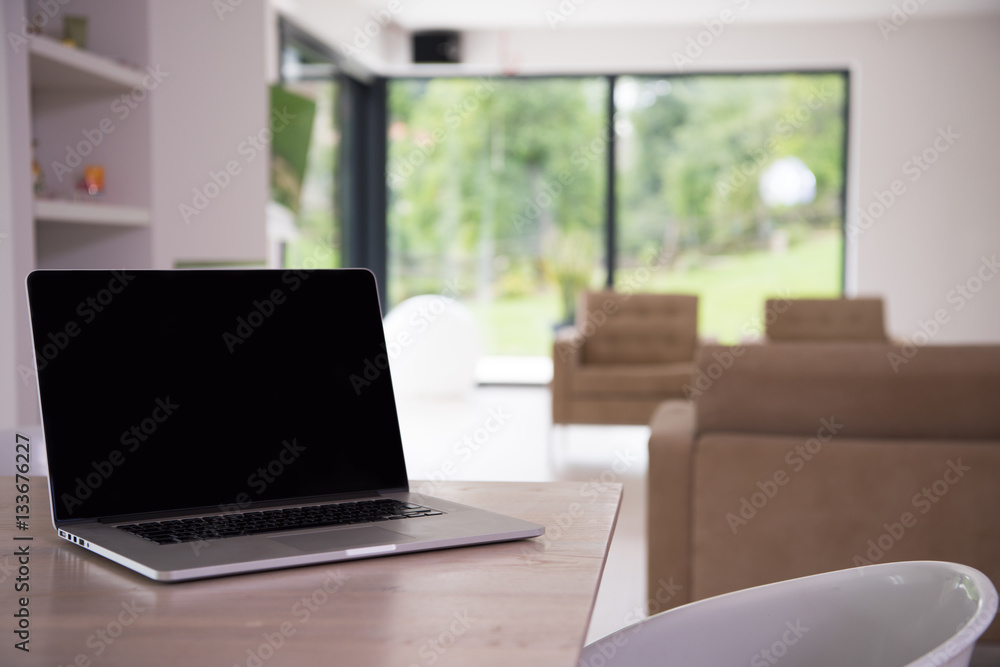 Notebook with blank screen on table Notebook with blank screen on table