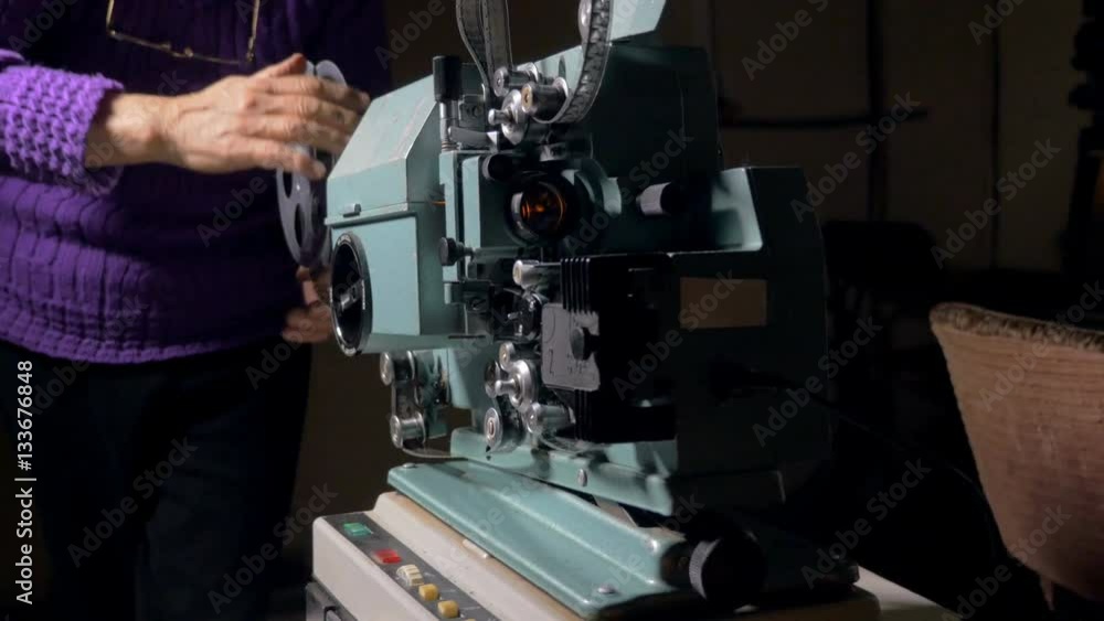Film projector. Cameraman setting old movie projector. 4K Film projector. Cameraman setting old movie projector. 4K