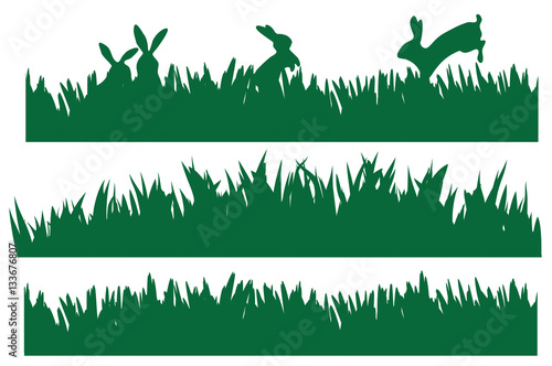 Vector rabbits in green grass silhouettes.