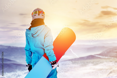 Snowboarder woman girl sunrise mountain top