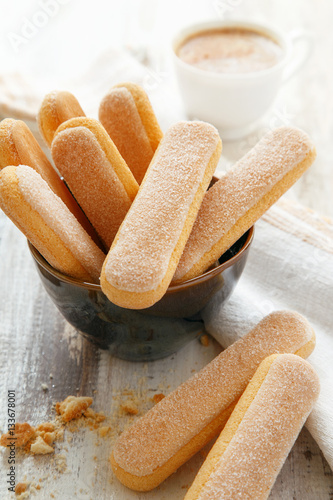 Ladyfingers in a bowl, coffee in the background. Tiramisu ingredients