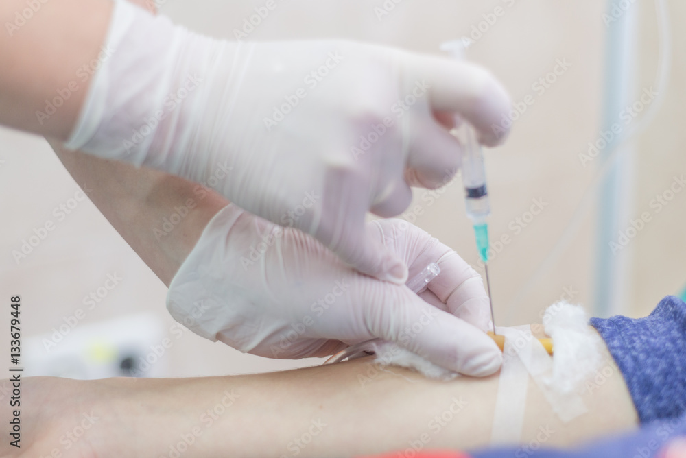 Shot of human hands making an injection with a syringe Shot of human hands making an injection with a syringe